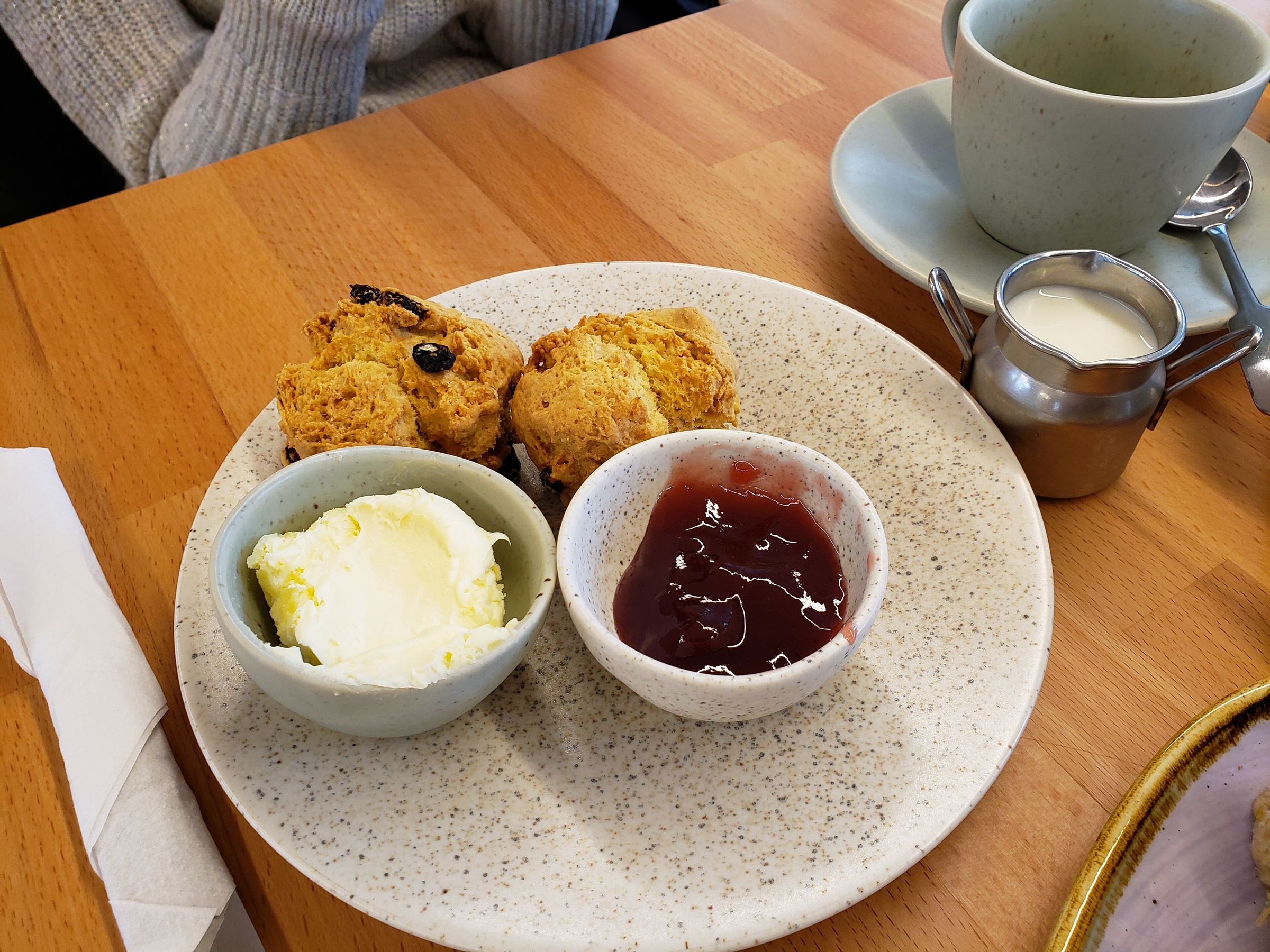 A cream tea: two fruit scones with clotted cream and jam